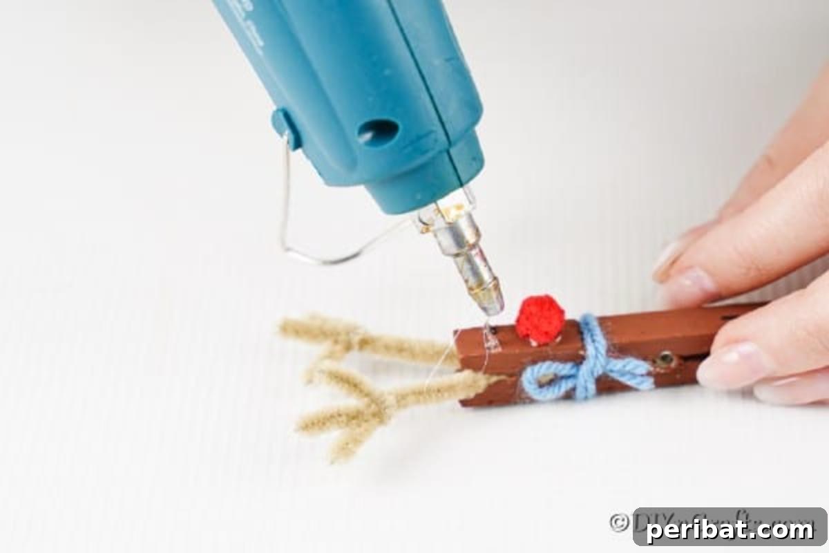 Transform Clothespins Into Adorable Reindeer Ornaments 14 Gluing googly eyes onto the clothespin reindeer