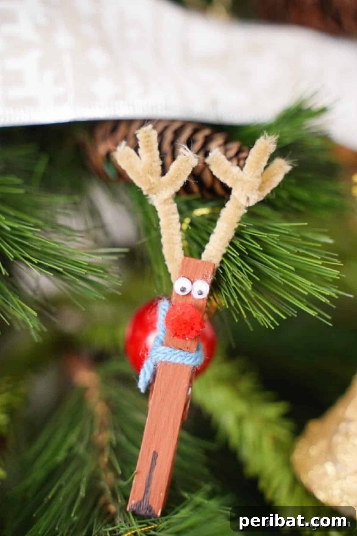 Transform Clothespins Into Adorable Reindeer Ornaments 15 The clothespin reindeer ornaments on display in a Christmas tree