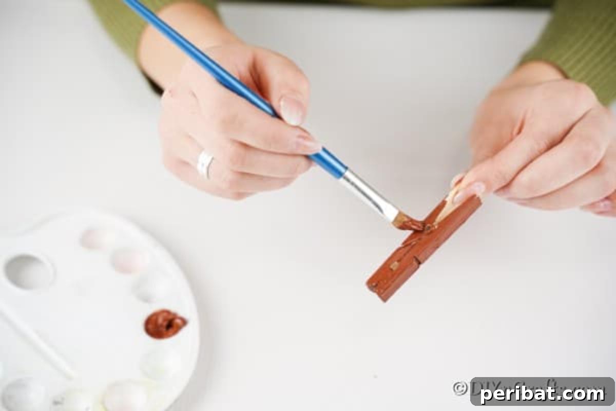 Transform Clothespins Into Adorable Reindeer Ornaments 8 Painting the clothespin for the reindeer ornament