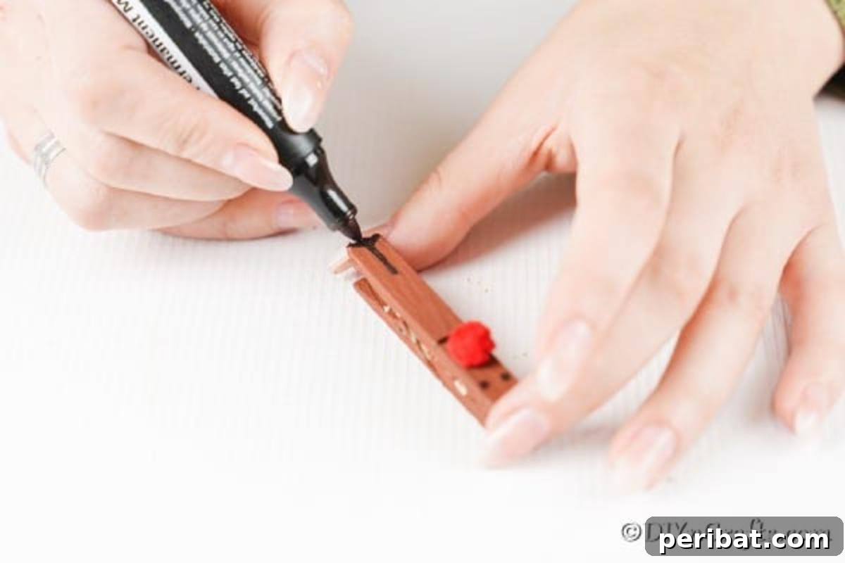 Transform Clothespins Into Adorable Reindeer Ornaments 10 Drawing on legs for the clothespin reindeer