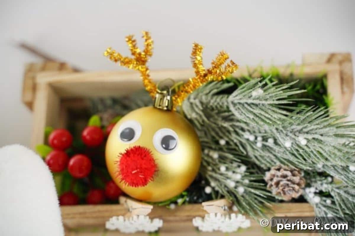 Rudolph's Dazzling Christmas Tree Bauble 3 Shiny Rudolph the Red-Nosed Reindeer Christmas Ornament with expressive googly eyes and a bright red nose, ready for display on a festive backdrop.