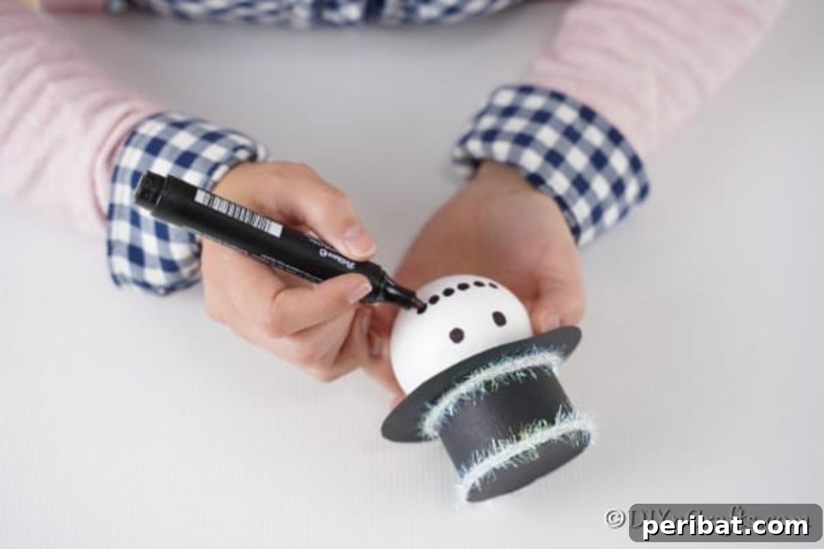 Adding a smile and eyes to the snowman face