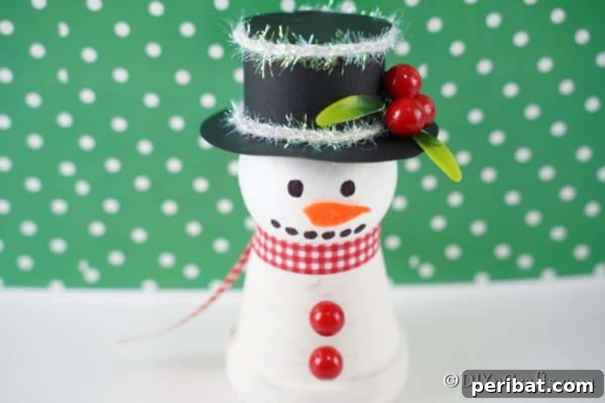 Snowman decoration in front of green polka dot background