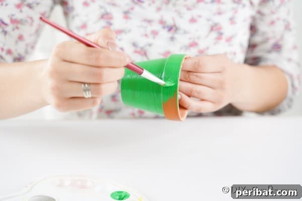 Craft Your Own Adorable Christmas Bell Ornaments 15 Painting flower pot green to make a bell