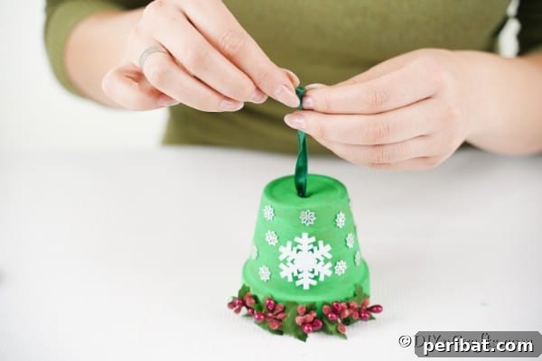 Craft Your Own Adorable Christmas Bell Ornaments 20 Adding the ribbon and bells to the Christmas bell decoration