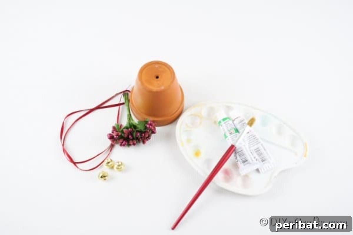 Craft Your Own Adorable Christmas Bell Ornaments 6 A flat lay photograph showcasing all the supplies needed to create a DIY Christmas bell: a clay pot, green paint, paintbrush, ribbon, jingle bells, artificial berries and leaves, snowflake stickers, scissors, and a hot glue gun