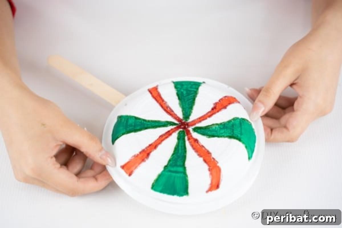 Gluing additional plate onto the giant lollipop decoration