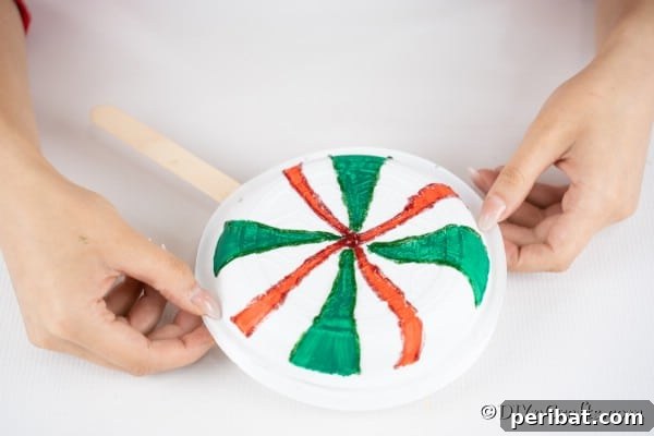 Gluing additional plate onto the giant lollipop decoration