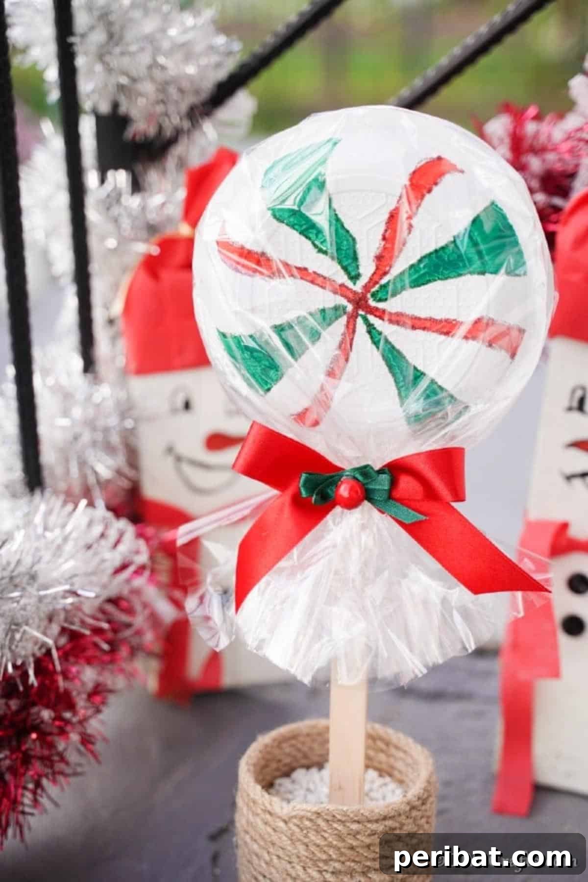 Peppermint giant lollipop decoration on a decorated front porch
