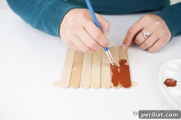 Whimsical Wooden Gingerbread House Charm 24 Painting craft sticks brown for making the gingerbread house base