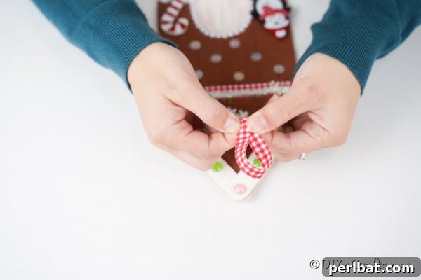Whimsical Wooden Gingerbread House Charm 28 Adding a ribbon hanger to the gingerbread house ornament