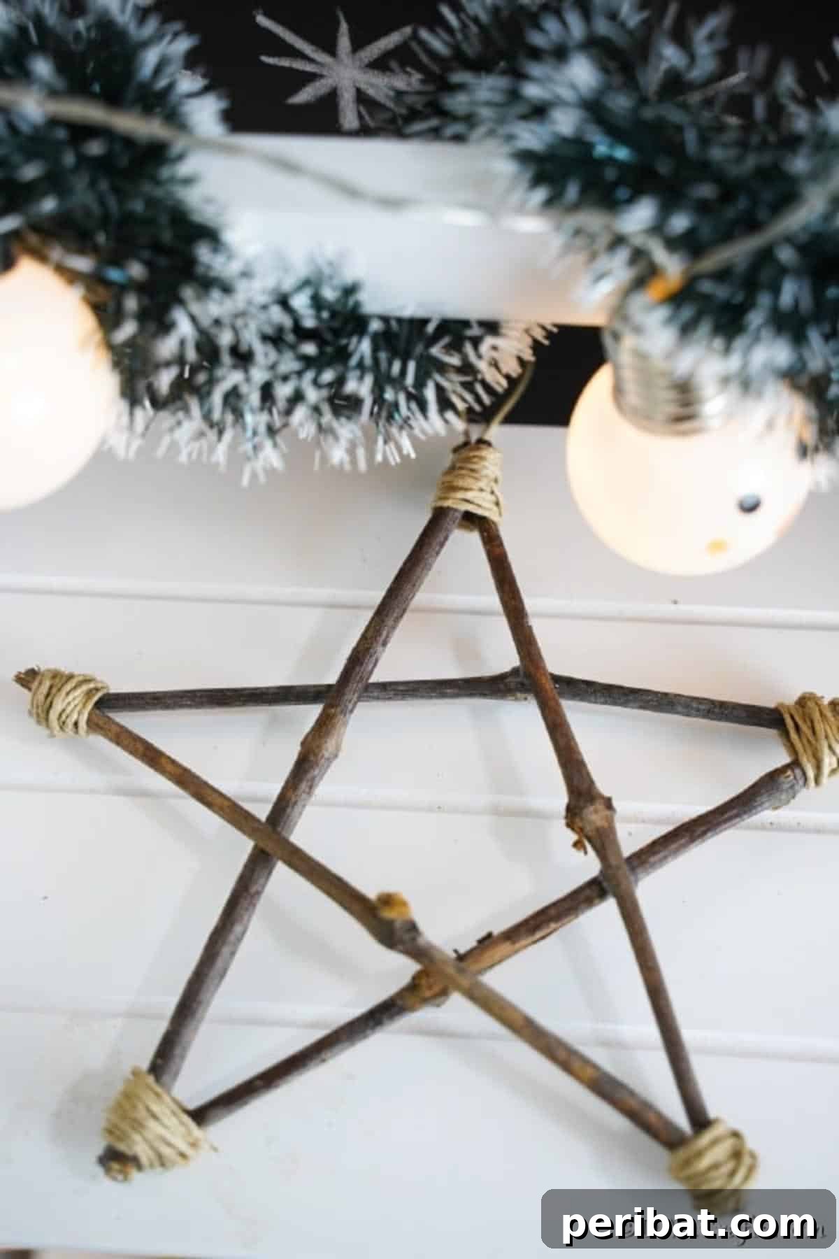 DIY Rustic Twig and Branch Christmas Ornaments 10 A finished rustic Christmas ornament star resting on a wooden table, showcasing its simple elegance.
