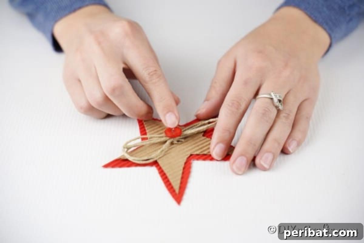 Adding a red button inside the bow on a Christmas star