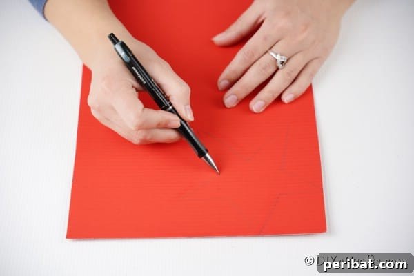 Drawing a star on cardboard for a Christmas star