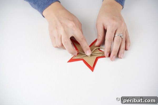 Adding a rustic thread bow to the middle of the Christmas star