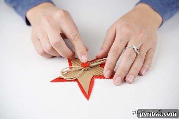 Adding a red button inside the bow on a Christmas star