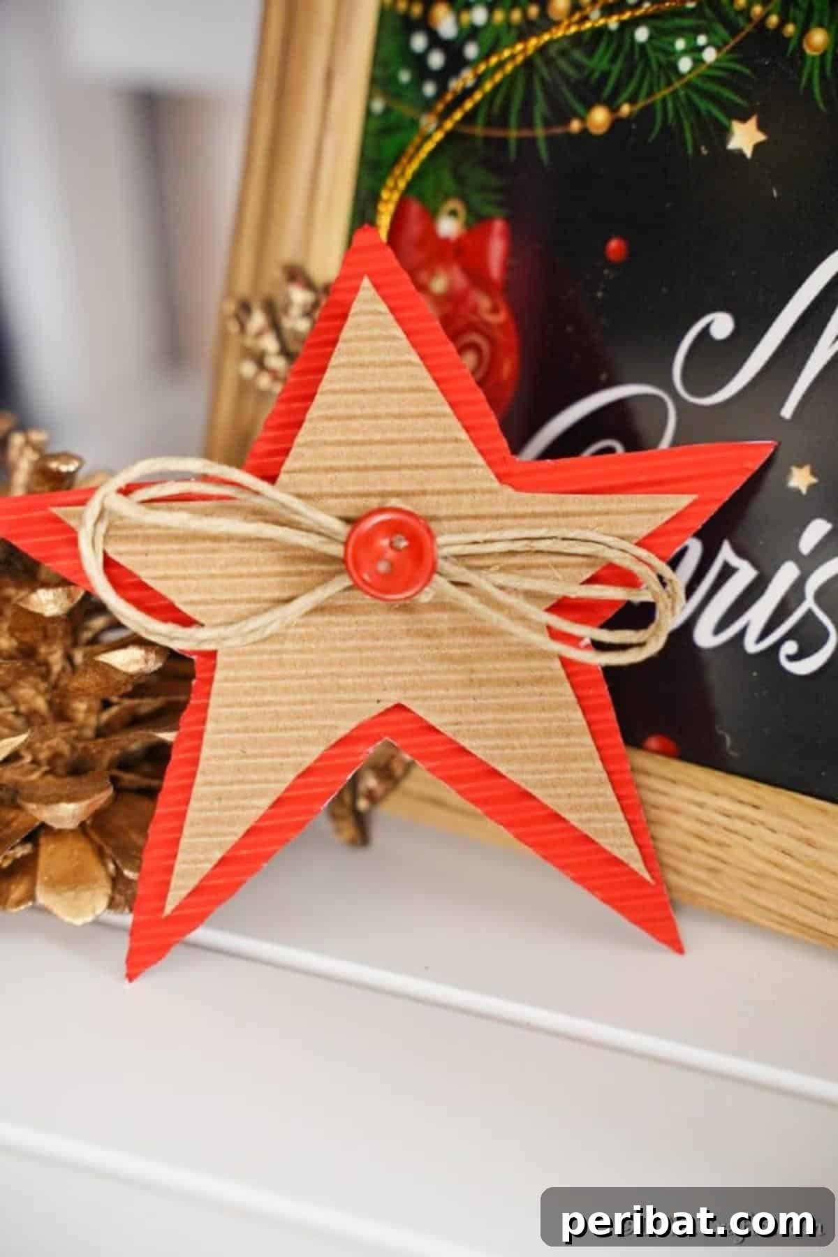 A cardboard Christmas star decoration next to a holiday sign