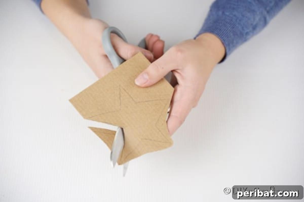 Cutting out a brown star from cardboard for the Christmas star