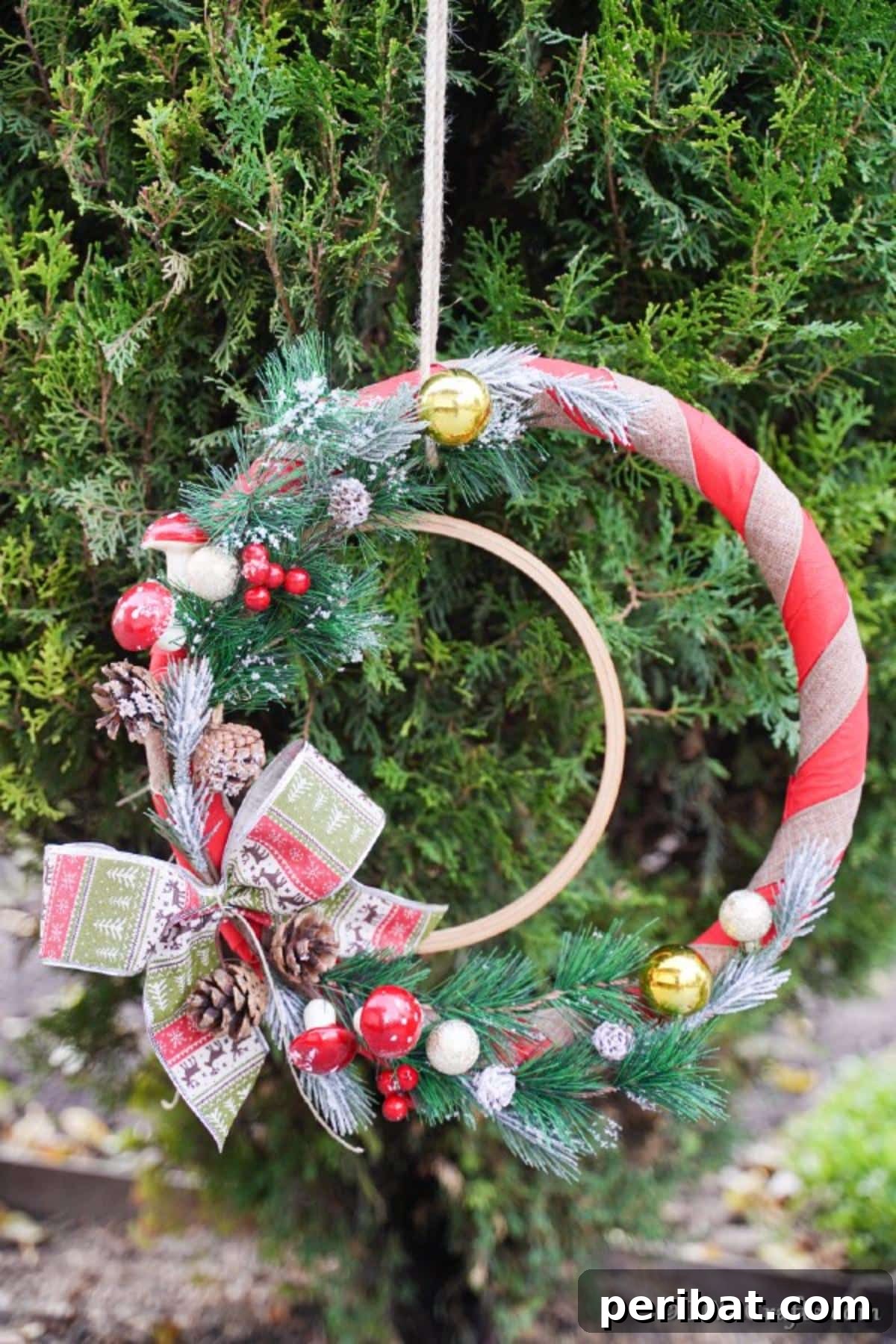 Deck Your Door: DIY Christmas Wreaths 5 A rustic diy Christmas wreath hanging on a cedar bush outside