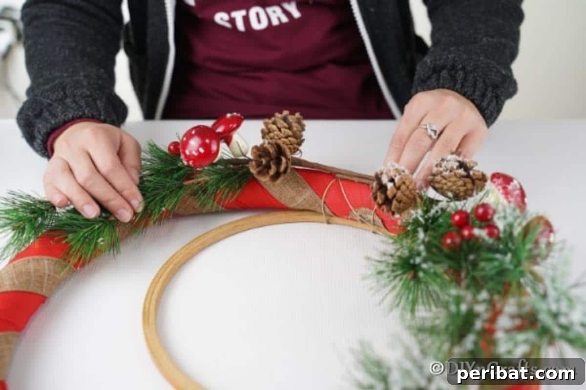 Deck Your Door: DIY Christmas Wreaths 10 Decorating the holiday wreath with greenery and berries