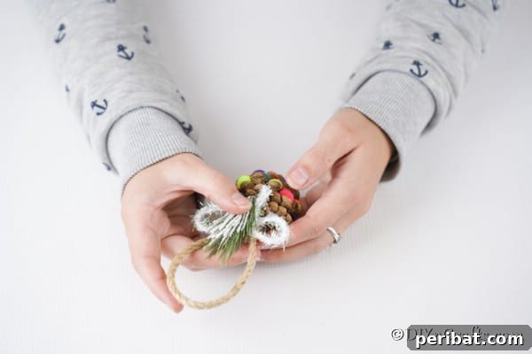 Vibrant Pinecone Christmas Decorations 15 Adding a bow and embellishment to the top of pinecone ornaments