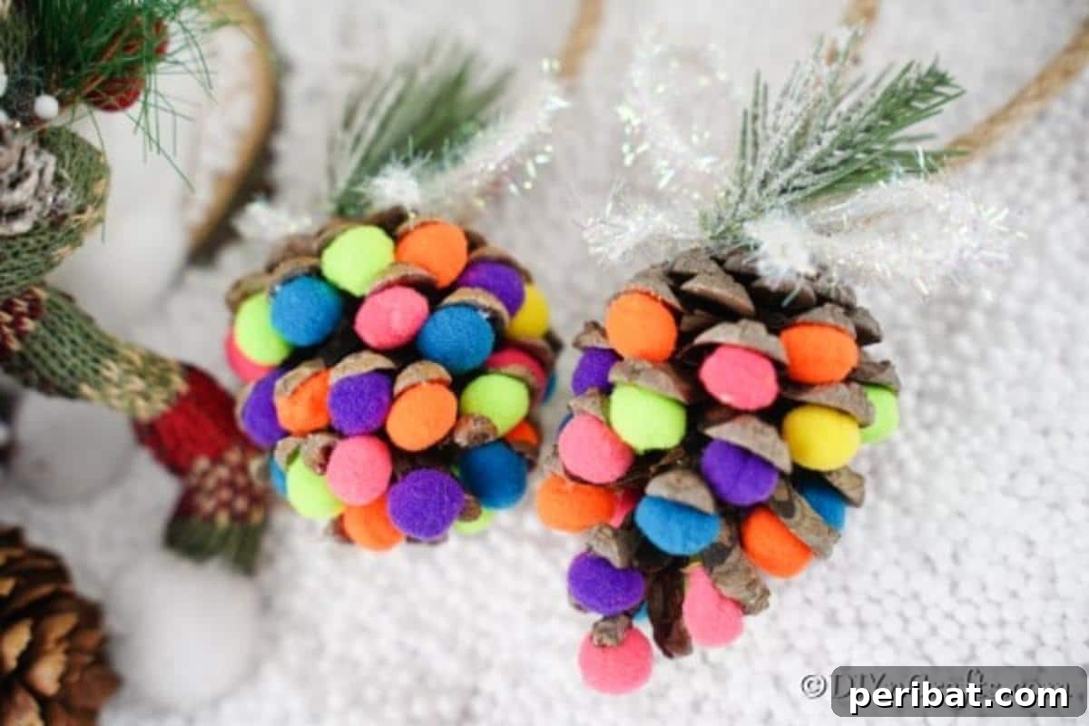 Vibrant Pinecone Christmas Decorations 3 Colorful pinecone ornaments with pom poms displayed against a clean white background.