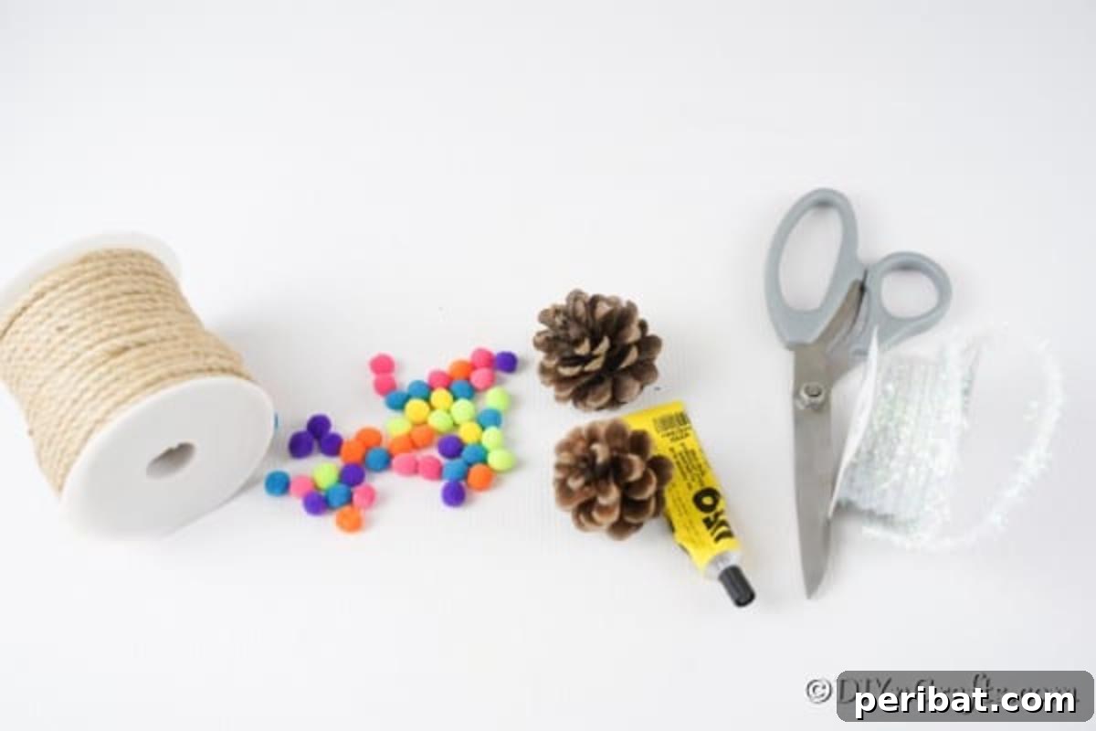 Vibrant Pinecone Christmas Decorations 6 A flat lay image displaying all the necessary supplies arranged neatly to make pinecone ornaments with pom poms, including pinecones, pom poms, glue, ribbon, and scissors.