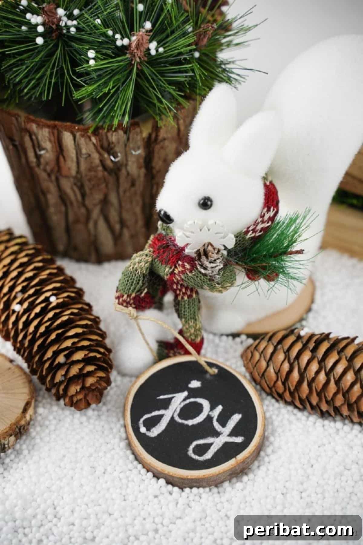 Rustic Wood Slice Chalkboard Charm 11 A festive wood slice chalkboard ornament with 'JOY' written in elegant chalk, resting on a wooden surface beside pinecones and fairy lights, embodying rustic holiday cheer.