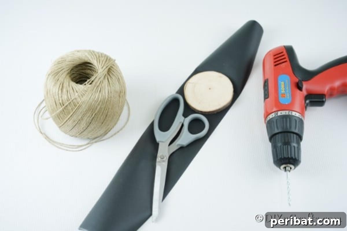 Rustic Wood Slice Chalkboard Charm 4 A flat lay photograph showcasing all the essential supplies needed to create rustic wood slice chalkboard ornaments, including wood slices, chalkboard paper, rustic twine, chalk, scissors, drill, and a pencil, neatly arranged for a DIY crafting project.