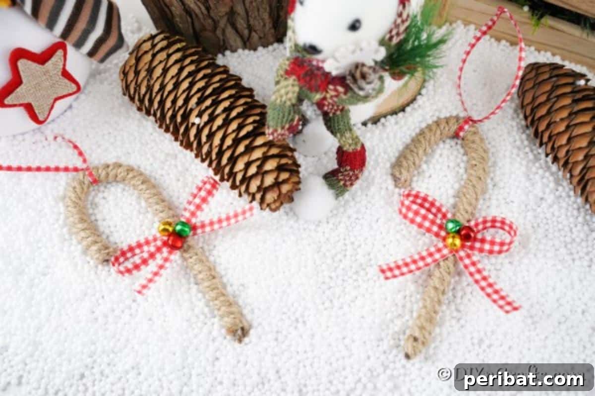 Farmhouse Jute Candy Cane Bauble 3 Candy cane ornaments laying on a white surface