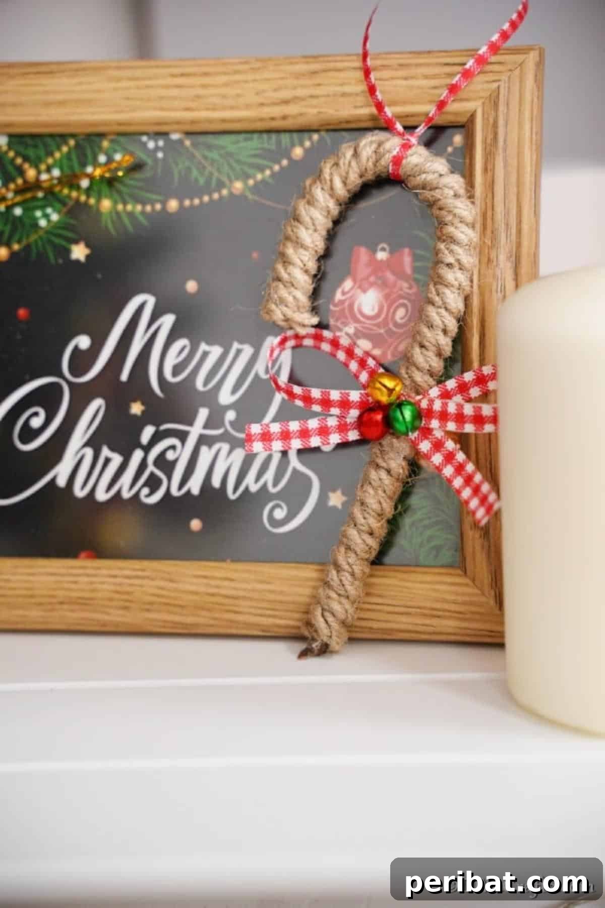 Farmhouse Jute Candy Cane Bauble 4 Candy cane ornament leaning against a Christmas sign