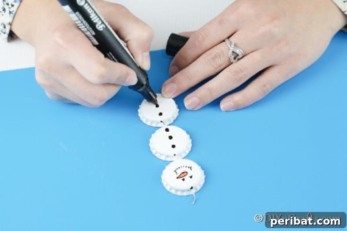 Upcycled Bottle Cap Snowman Charms 11 Adding buttons down front of snowman ornaments