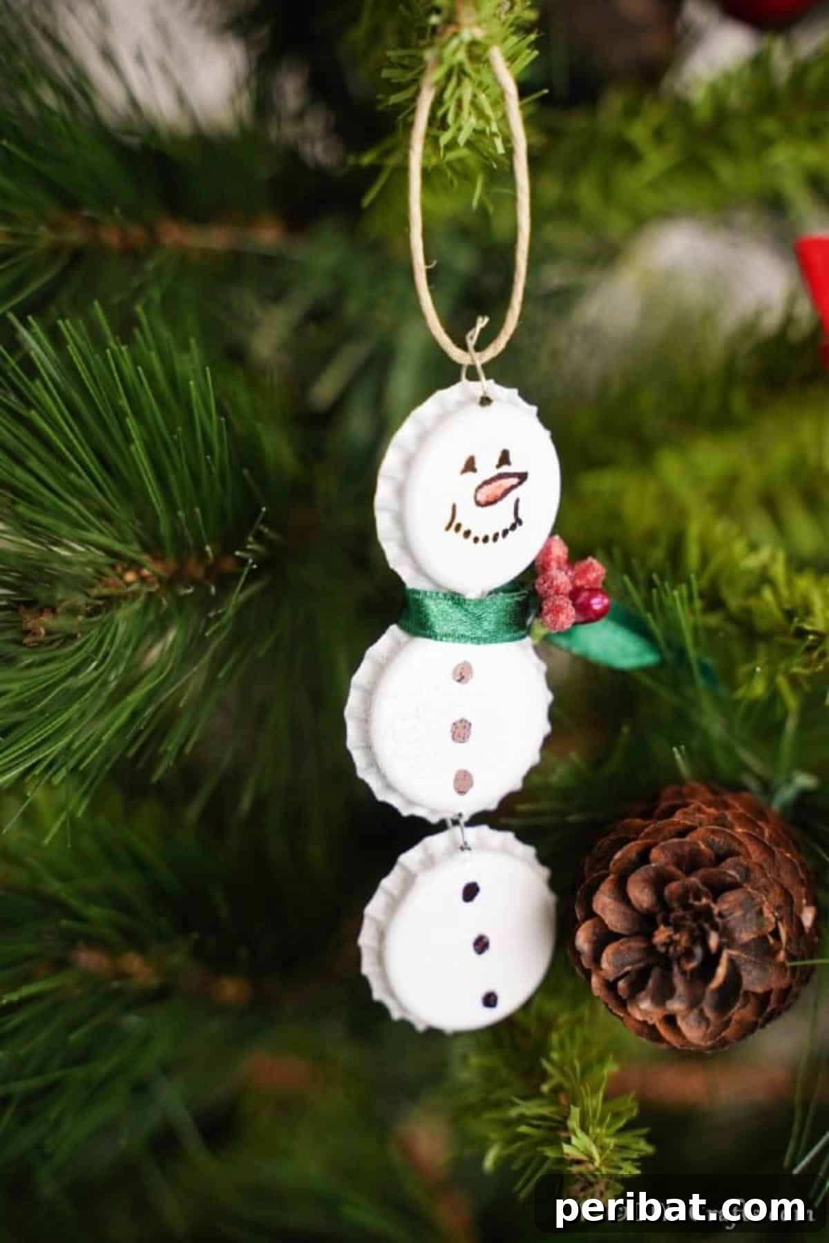 Upcycled Bottle Cap Snowman Charms 3 Up close picture of bottle cap snowman ornaments on a tree