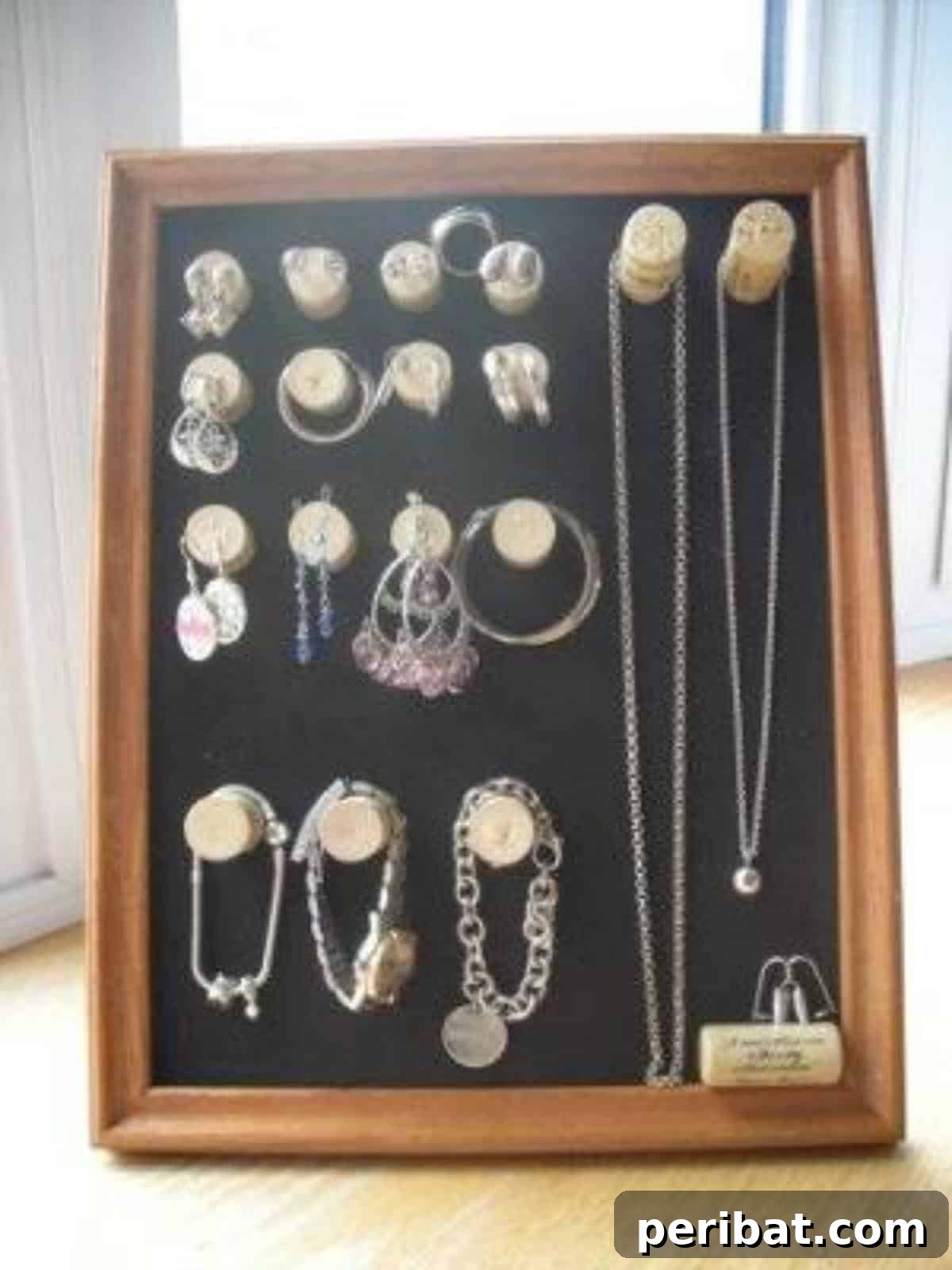 Uncork Your Creativity with DIY Wine Cork Projects 5 Jewelry display board made from a repurposed frame and wine corks
