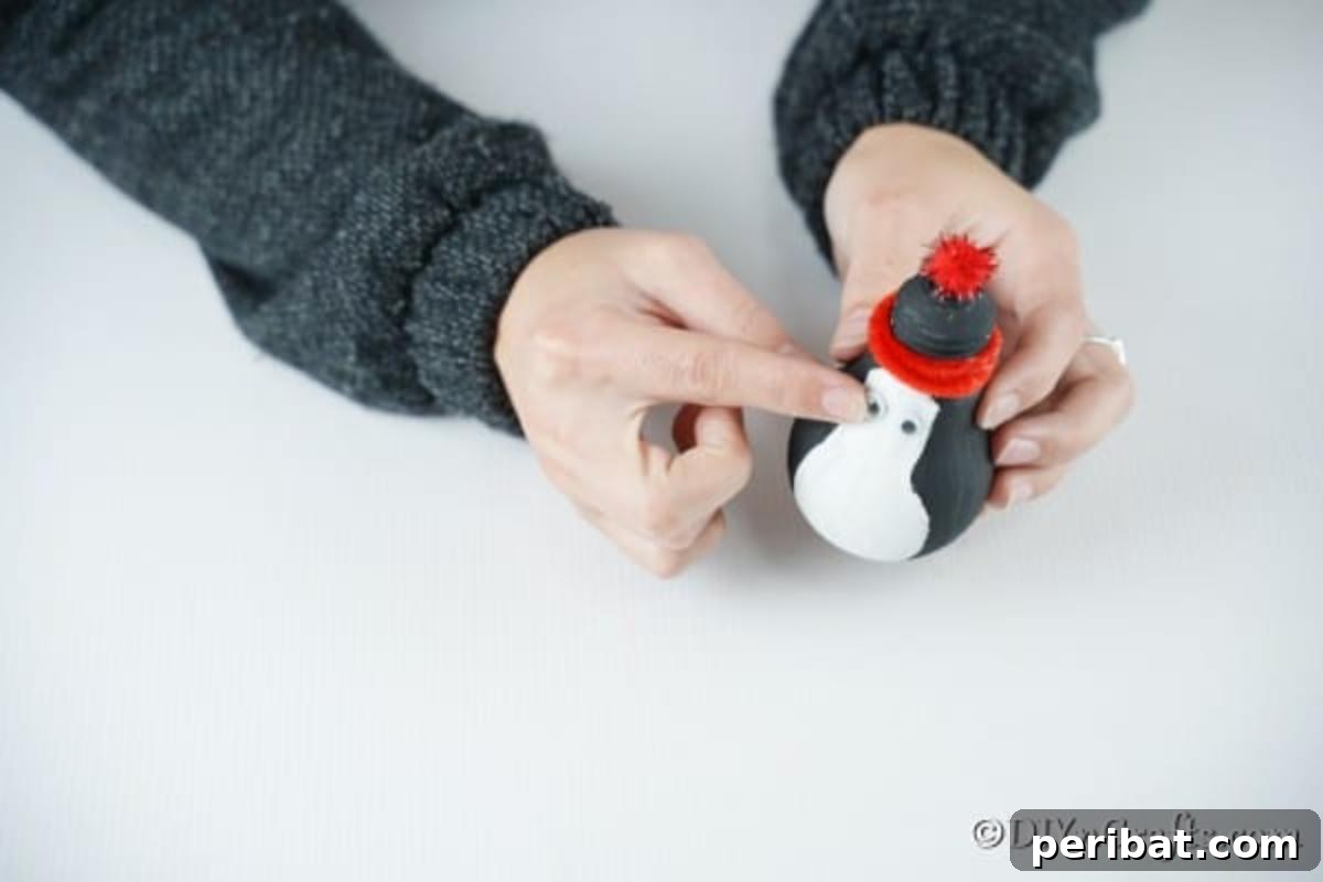 Adding eyes and nose to the penguin lightbulb