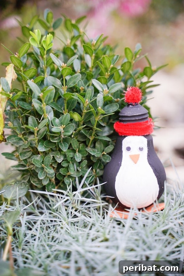 A penguin decoration in front of greenery