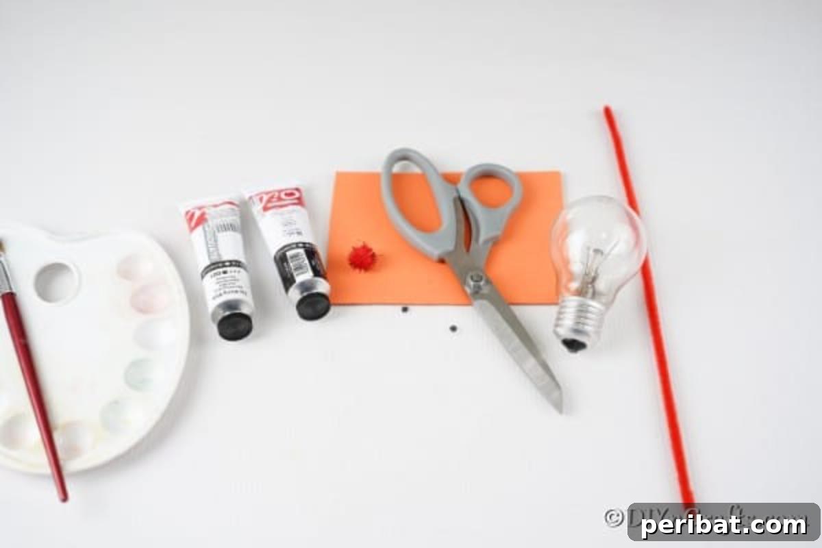 Supplies for making a light bulb penguin decoration