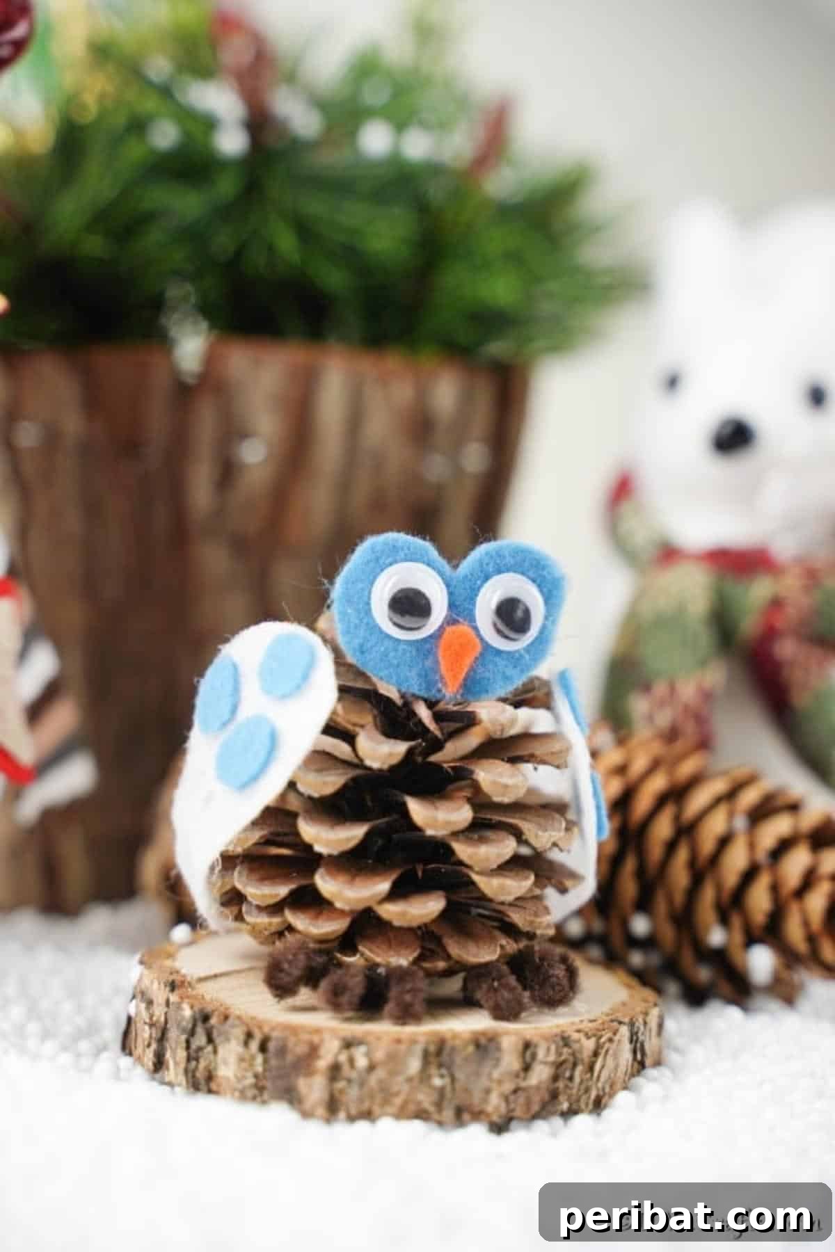 Whimsical Winter Pinecone Owl Decorations 4 A pinecone owl decoration sitting on a wood slice amidst a natural setting