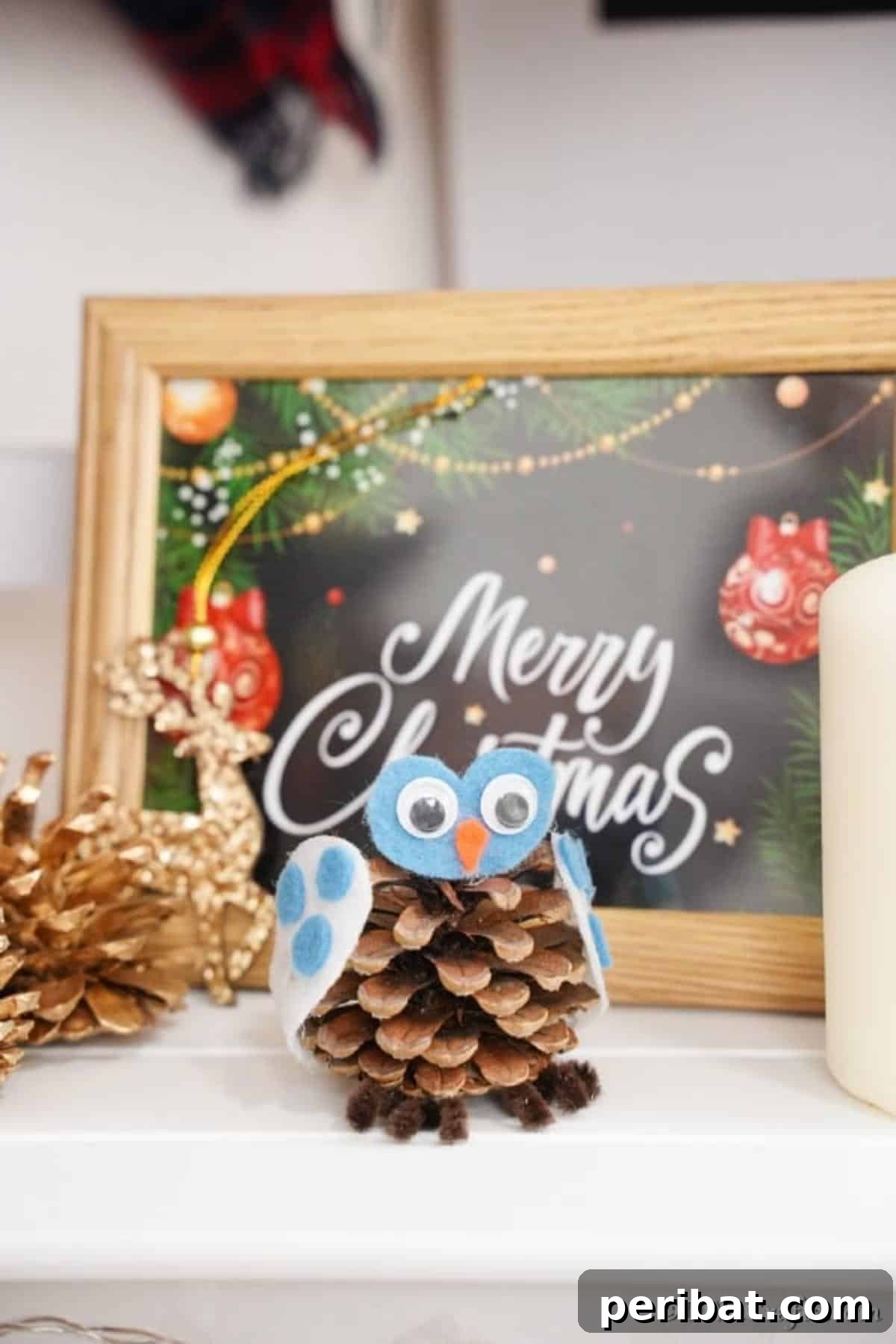 Whimsical Winter Pinecone Owl Decorations 5 A pinecone owl sitting in front of a festive Christmas sign