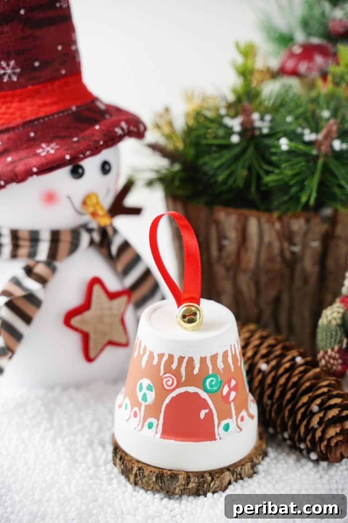 A charming gingerbread house clay pot proudly displayed on a mantle, surrounded by other festive holiday decorations, creating a warm and inviting atmosphere.