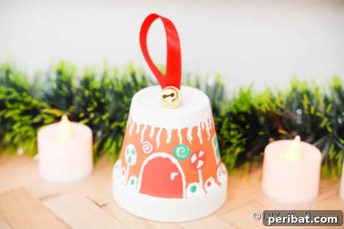 A beautifully decorated flower pot gingerbread house displayed on a wooden table, surrounded by lush green foliage and festive lighting, creating a cozy holiday scene.