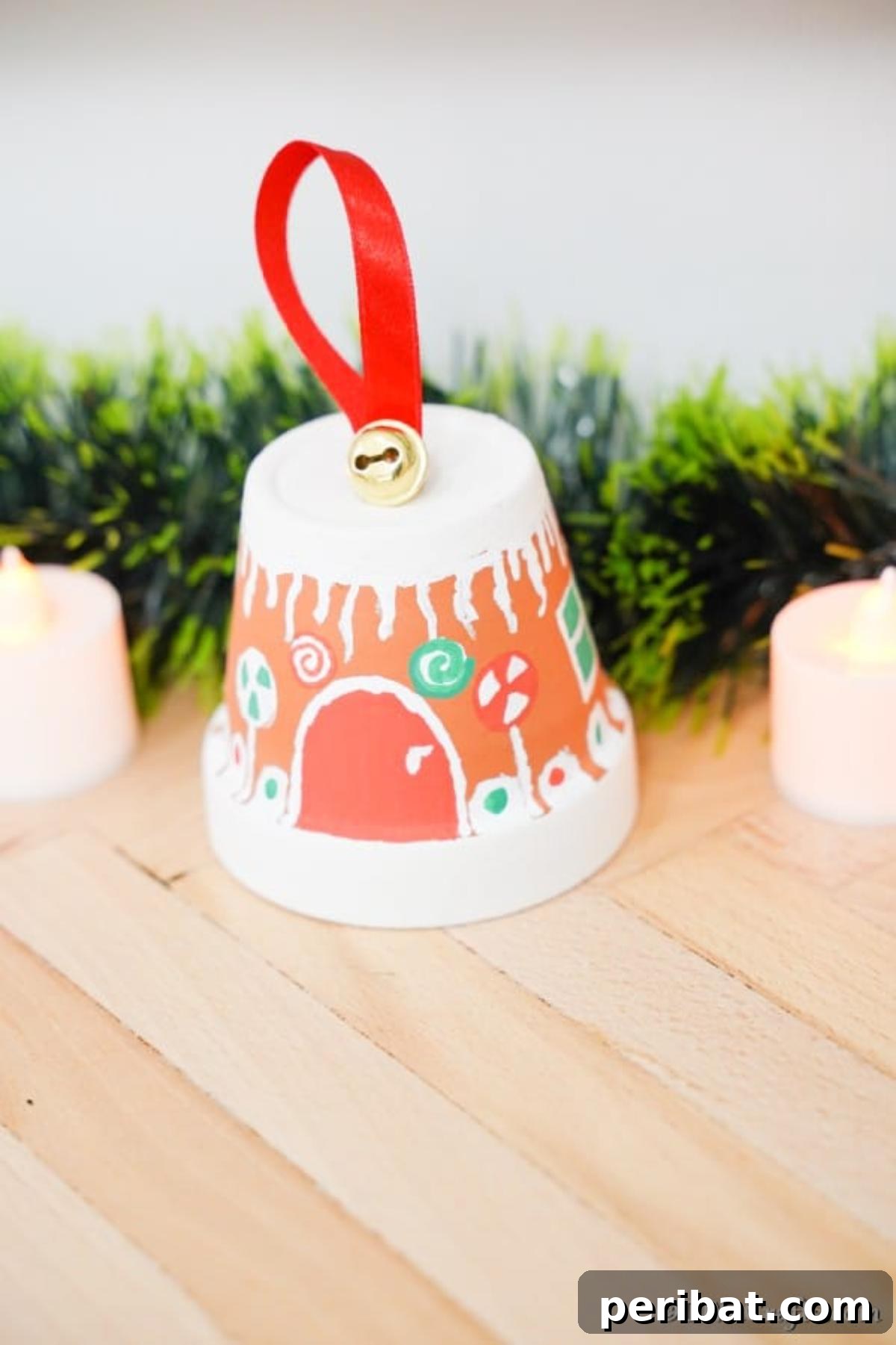 A solitary gingerbread house crafted from a flower pot, positioned on a rustic wooden table with soft focus greenery in the background, evoking a cozy winter atmosphere.