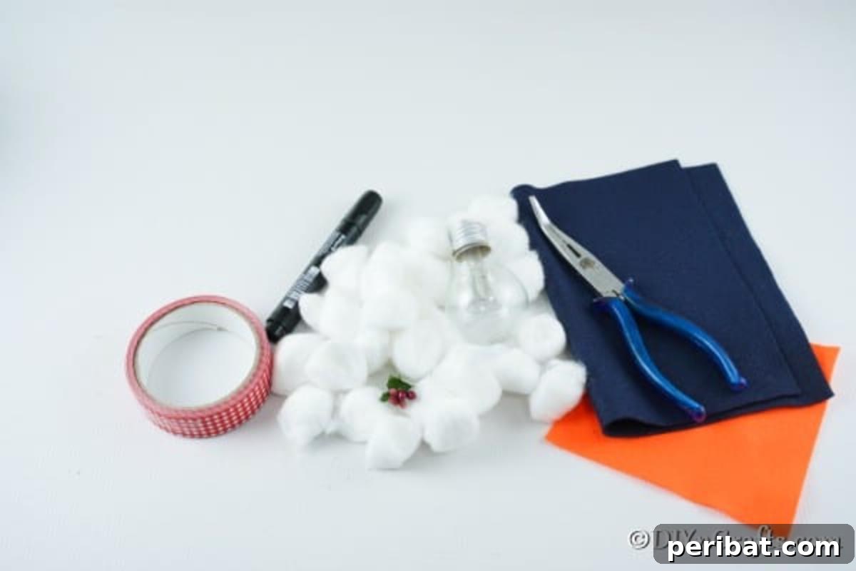 A neatly arranged collection of supplies needed for making a light bulb snowman ornament, including a bulb, ribbons, fabrics, and tools