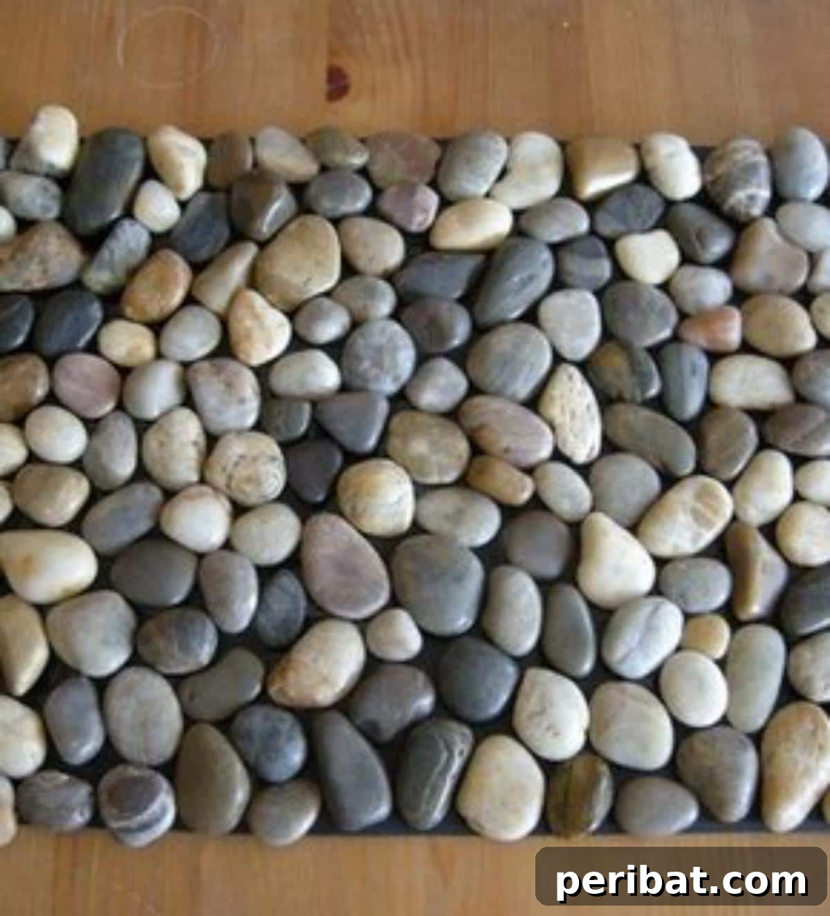 Handmade pebble bath mat created from dollar store river rocks