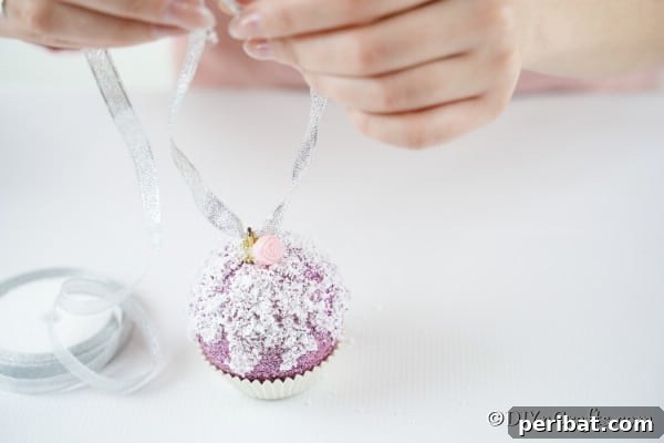 Sparkling DIY Cupcake Christmas Ornaments 19 Adding a ribbon to the top of an ornament to make it look like a muffin or cupcake