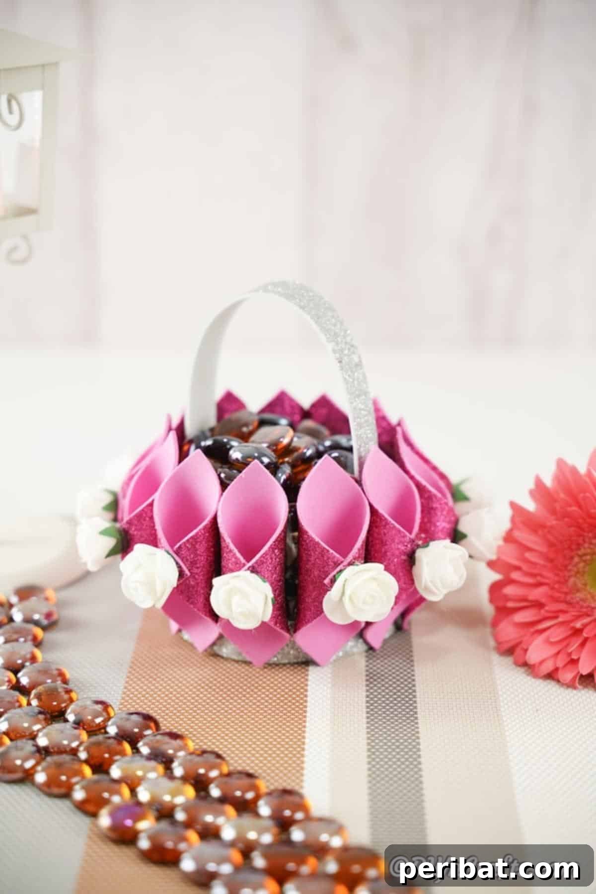 Shimmering Pink Paper Bloom Basket 5 Pink flower basket on a table with stone decoration, highlighting its charming details as a decor item