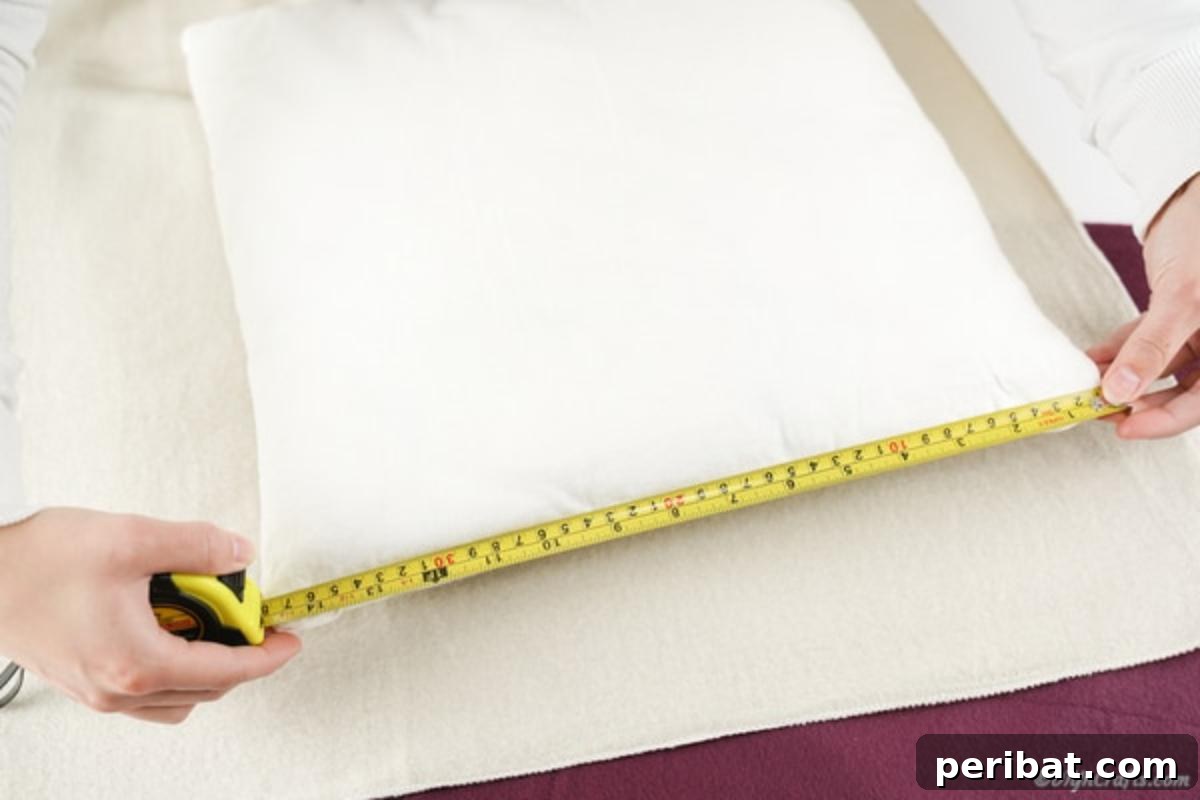 Easy 30-Minute No-Sew Reversible Fleece Pillow 6 Measuring a standard throw pillow with a ruler to determine fabric dimensions.