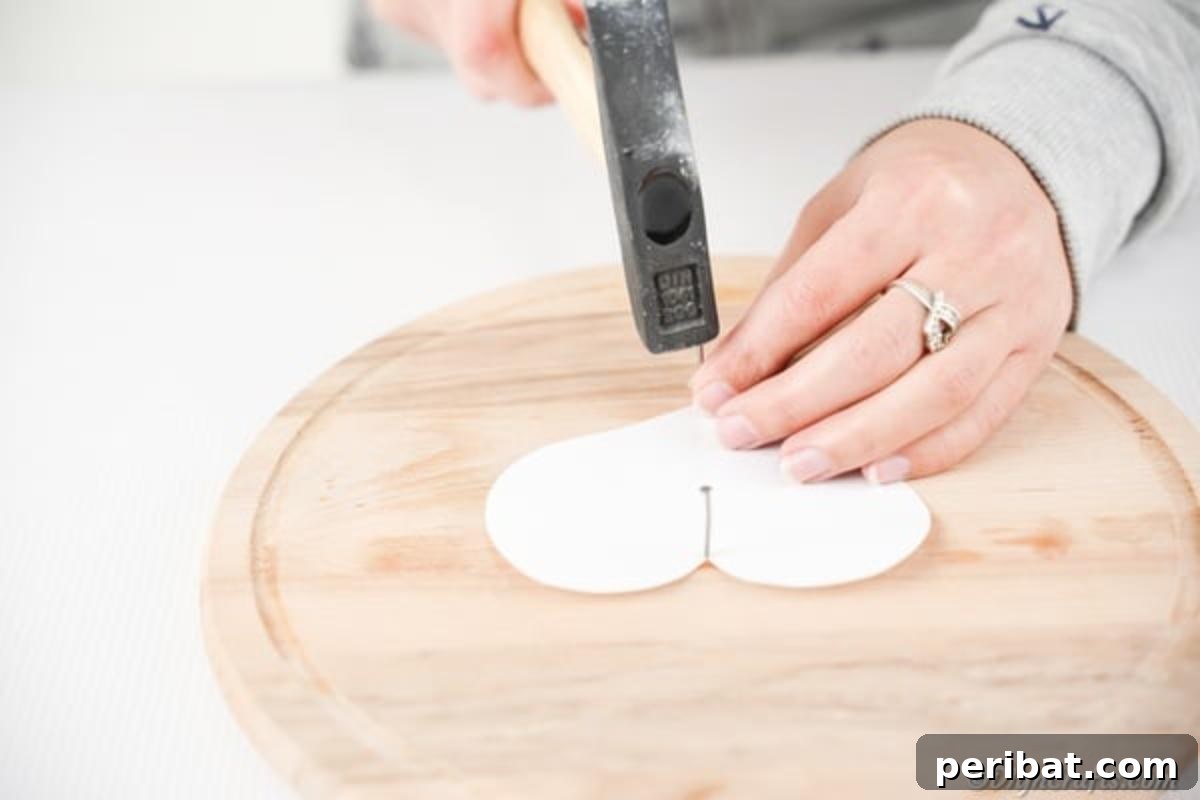 Heartfelt Valentine String Art Decoration 10 Nailing a paper template onto wooden board