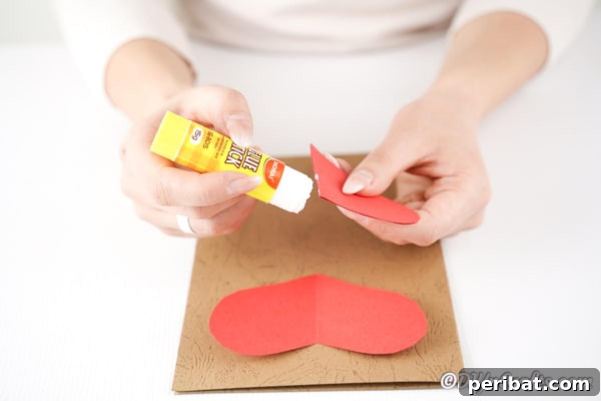 Gluing paper heart to craft paper