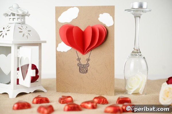 A 3D hot air balloon valentine's day card on table with heart candies